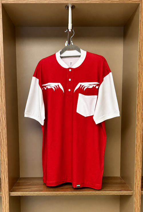 Red and white baseball jersey hanging in a wooden locker.